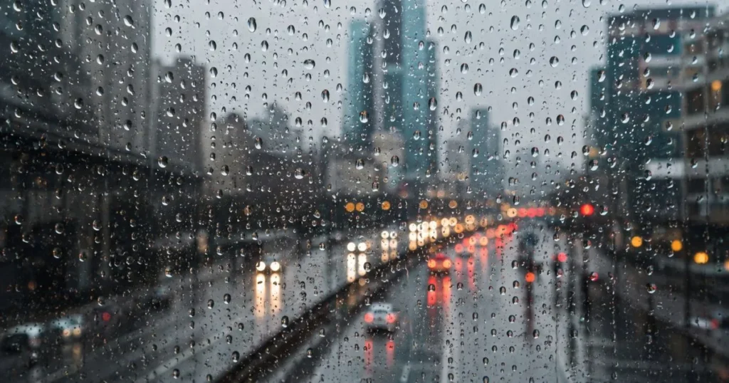 Raindrops falling on a window during a rainy day